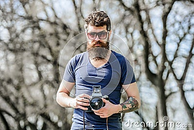 Photographer hold vintage camera. Modern blogger. Content creator. Man bearded hipster photographer. Photographer with Stock Photo