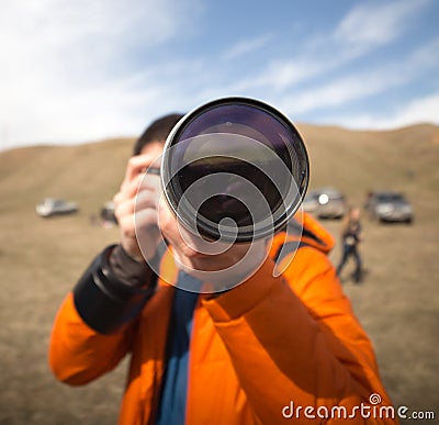 Photographer with a large lens Stock Photo