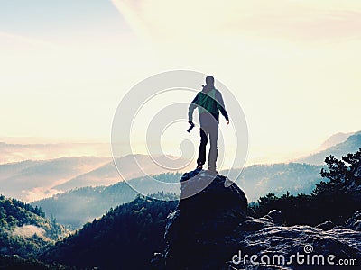 Photographer looks into the landscape and listen the silence. Man prepare camera to takes photos Stock Photo