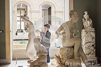 Photographer in Roman sculpture gallery, Louvre, Paris Editorial Stock Photo