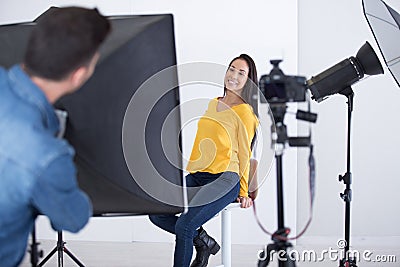 photographer shooting model in studio with softboxes Stock Photo