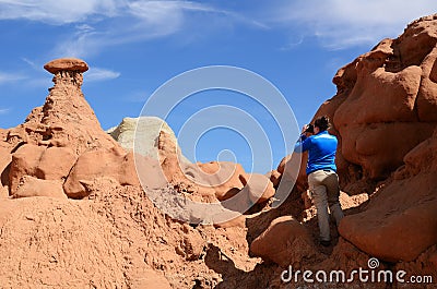 Photographer Shooting Sandstone Rock Formation (Hoodoo) in Goblin Valley Stock Photo