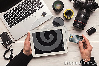 Photographer shopping online with digital tablet Stock Photo