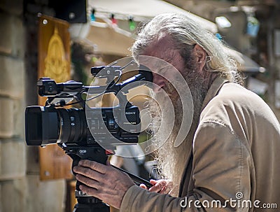 Photographer with silver hair and long beard Editorial Stock Photo