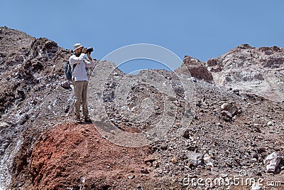 Photographer takes a photo in deserted area Hormuz Island, Iran Stock Photo
