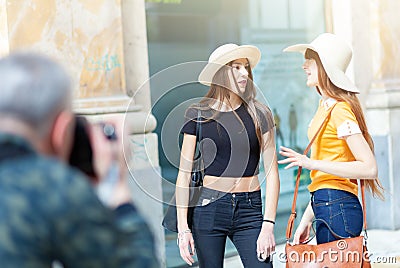 Photographer takes photographs of two models Stock Photo