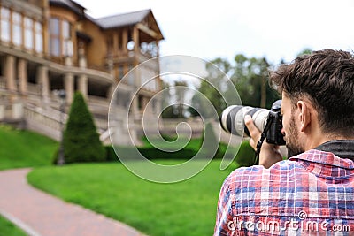 Photographer taking photo of beautiful house with camera outdoors Stock Photo