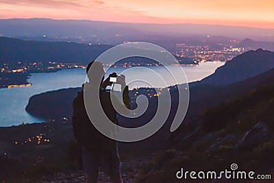 Photographer taking photo on dslr camera at night after sunset twilights, city lights Stock Photo