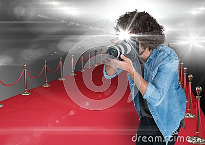 photographer taking a photo with flash in the red carpet. Flares everywhere Stock Photo