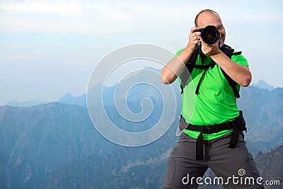 Photographer taking photo in the mountains Stock Photo