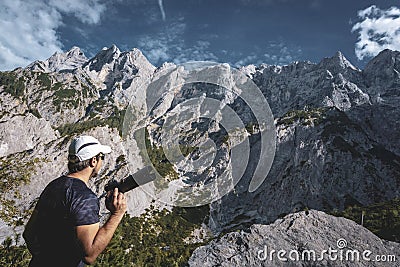 Photographer taking photos in front of impressive mountainscape Stock Photo