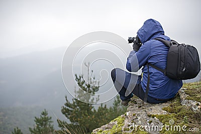 Photographer taking photos in the mountains. Stock Photo