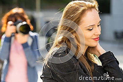 Photographer taking pictures of woman outdoor Stock Photo