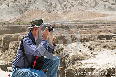 Photographer traveler with camera in nature Stock Photo