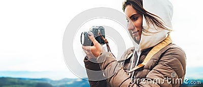 Photographer traveler on green top on mountain, tourist looking enjoy nature panoramic landscape in trip, girl holding in hands di Stock Photo