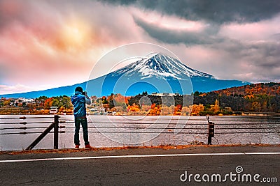 Photographer or Traveller using a professional DSLR camera take photo beautiful landscape of fuji lake at lake kawaguchi, Editorial Stock Photo