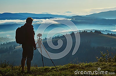 Photographer, Tripod Camera and Morning Panorama of the Carpathian Mountains Stock Photo