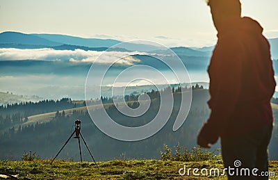 Photographer, Tripod Camera and Morning Panorama of the Carpathian Mountains Stock Photo