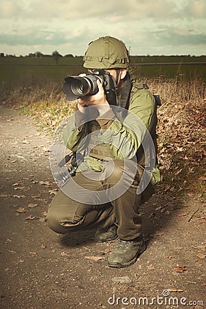 Journalist photographer in war conflict zone taking pictures Stock Photo