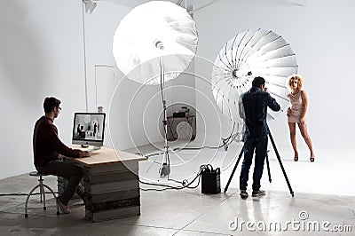 Photographer working with a Cute Model in a Professional Studio Stock Photo