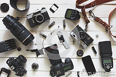 Photographer Workplace, Camera, Lenses And Accessories On White Wooden Background. Top View Stock Photo