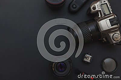 Photographer workplace with dslr camera system, camera cleaning kit, lens and camera accessory on dark black table background Stock Photo