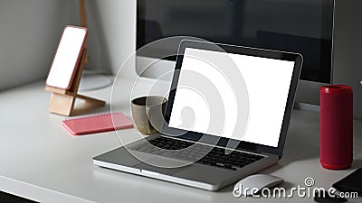 Photographer workspace with blank screen laptop, computer and smartphone. Stock Photo