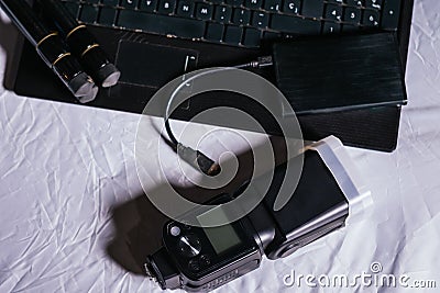 Photographer workspace with notebook,powerbank and speedlite Stock Photo