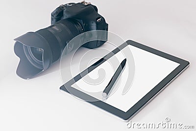 Photographer Workspace on white table, tablet and camera white s Stock Photo