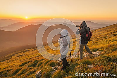 Photographers takes a sunset in the mountains Stock Photo