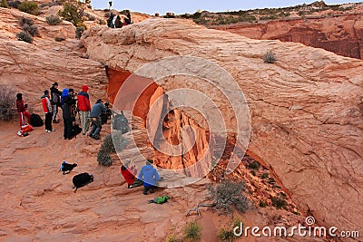 Photographers and tourists watching sunrise at Mesa Arch, Canyo Editorial Stock Photo