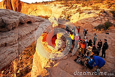 Photographers and tourists watching sunrise at Mesa Arch, Canyo Editorial Stock Photo