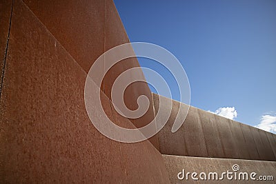 Photographic documentation of an iron wall thrown into the blue sky Stock Photo