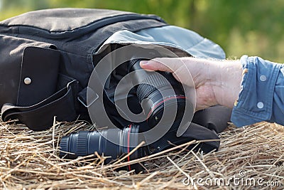 Photographic lens is lying on a haystack, countryside protographer concept Stock Photo