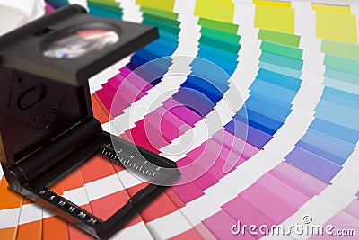 Photographic magnifying lupe and colour swatches Stock Photo