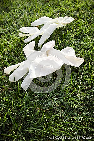 Disposable anti Coronavirus gloves thrown on the ground Stock Photo