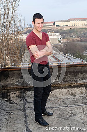 Photographing Danila MaziÄ‡ on old roof with a background Petrovaradin fortress and Danube river Stock Photo