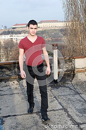 Photographing Danila MaziÄ‡ on old roof with a background Petrovaradin fortress and Danube river Stock Photo