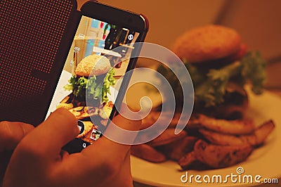 Photographing food at restaurant Stock Photo