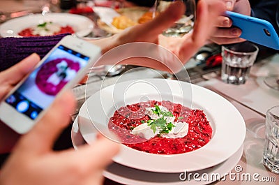 Photographing food at restaurant Stock Photo