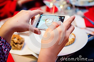 Photographing food at restaurant Stock Photo