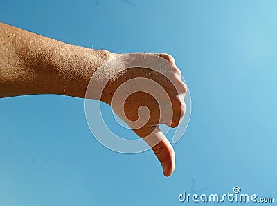 Photography of male hand showing thumb down gesture Stock Photo