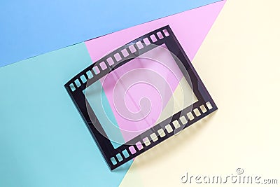 Photography picture frame in shape of vintage photo movie film strip negative on multicolored background minimalistic concept. Stock Photo