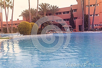 Photography of a residential area during the sunset with palms and pool Stock Photo