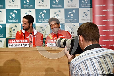 Photojournalist photographing tennis press conference Editorial Stock Photo