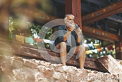 A photojournalist sits near the eastern temple and takes pictures. Retired travel and hobbies Stock Photo