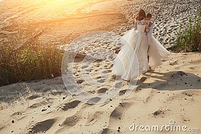Photoshoot lovers in a wedding dress on the beach near the sea Stock Photo