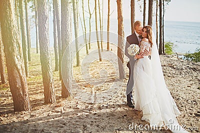Photoshoot lovers in a wedding dress on the beach near the sea Stock Photo