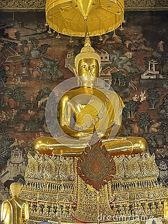 Phra Buddha Deva Patimakorn, a Gorgeous Sitting Postured Buddha Image in the Ordination Hall of Wat Pho Temple with Amazing Mural Stock Photo