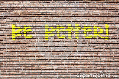 Phrase Be Better spray painted in yellow on a brick wall Stock Photo